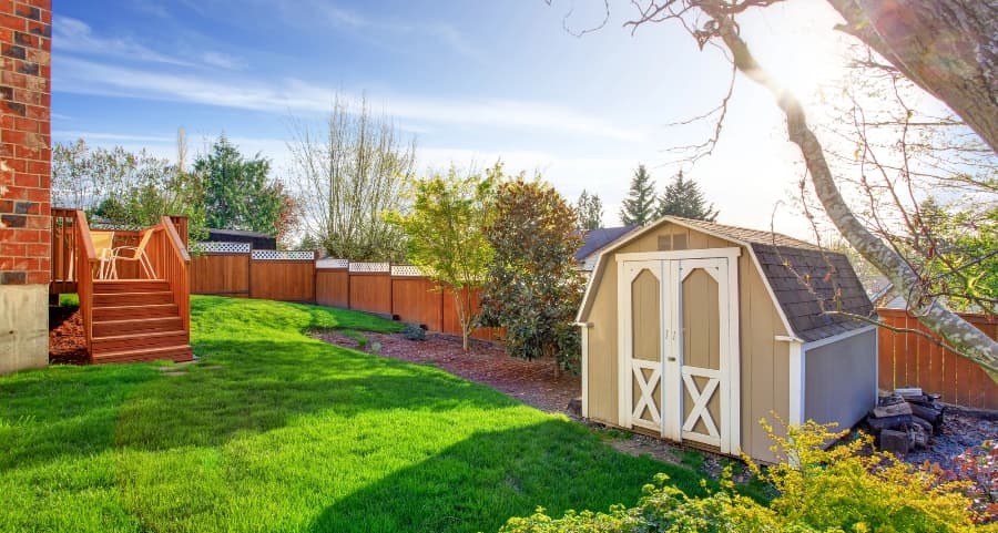 Fenced backyard with storage shed in Rochester